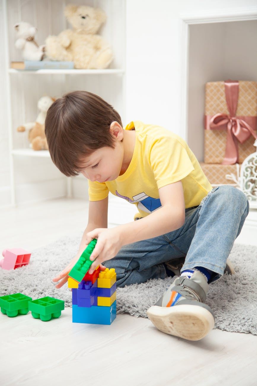 A child building with colorful toy blocks, like building in Salesforce