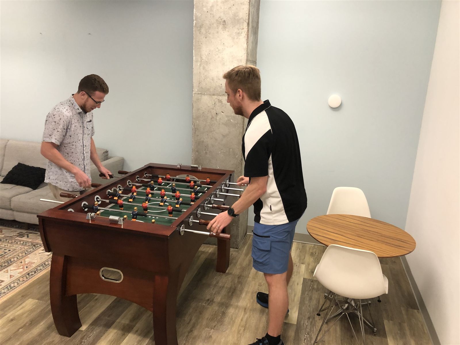 Blue Engine team members playing foosball
